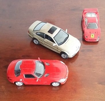 Picture of three toy cars including a Ferrari, to illustrate my post on why I think PCP car finance is madness