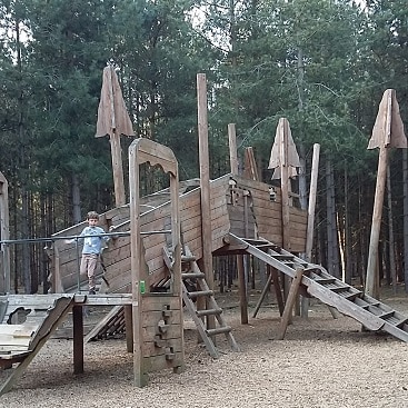 Picture of the amazing wooden adventure playround in Rendlesham Forest, with a huge wooden climbing frame like a crashed plane