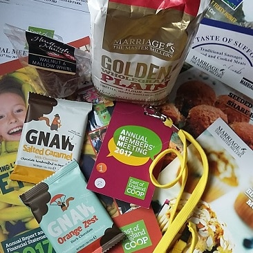Picture of the frugal freebies I picked up at the East of England Co-op Annual Members' Meeting, including Marriages flour, Gnaw chocolate, Hadleigh Maid chocolate, some recipe cards and my badge
