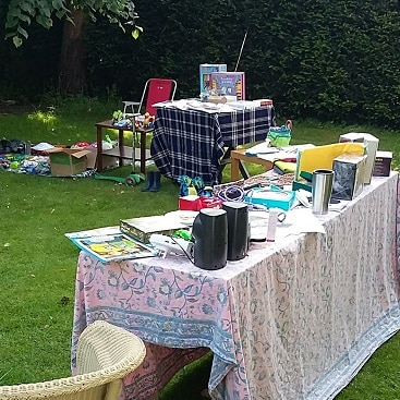 Picture of tables set up with all the stuff we wanted to sell at a successful yard sale