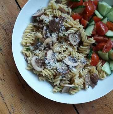 Picture of pasta meal made with yellow-stickered discount mushrooms and salad, made with minimal effort and less cost