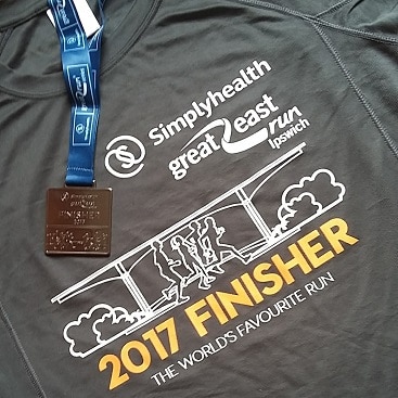 Picture of Great East Run Finisher T shirt and medal from running a half marathon