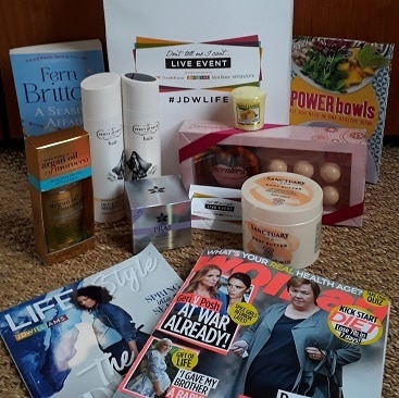 Picture of the contents of the Goody Bag from the Don't Tell Me I Can't event with toiletries, chocolates, books, magzines and a clothing discount voucher