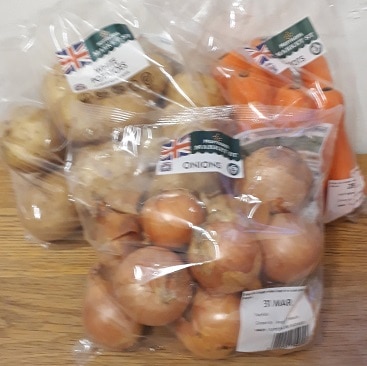 Picture of bags of potatoes, onions and carrots at 3 for £1 on an Easter offer