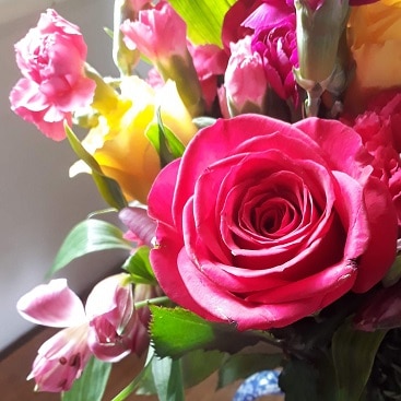 Picture of a bunch of flowers with pink and yellow roses from my 5 frugal things this week post