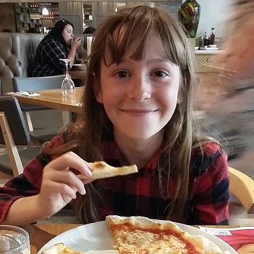 Picture of my daughter eating a pizza in Prezzo, which we visited during a frugal Febriary half term